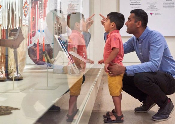 man and young child looking at exhibit in British Museum