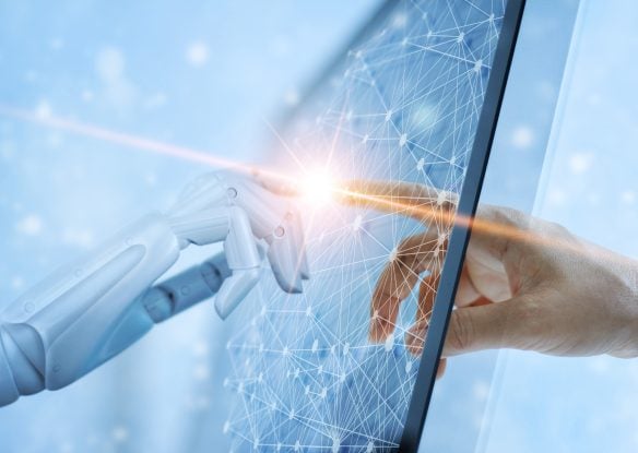 A robot and human hand touch with a transparent computer screen between them. The image evokes Michelangelo's The Creation of Adam work