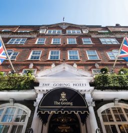 entrance to a hotel in London with British flags flying